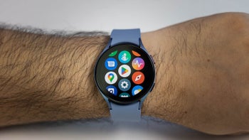 Galaxy Watch on a man's wrist with app icons displayed.