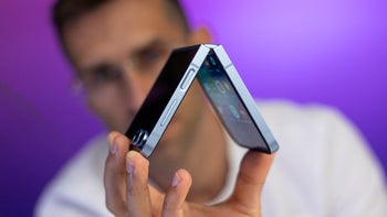 The Galaxy Z Flip 6 in a person's hand in a half-folded state.
